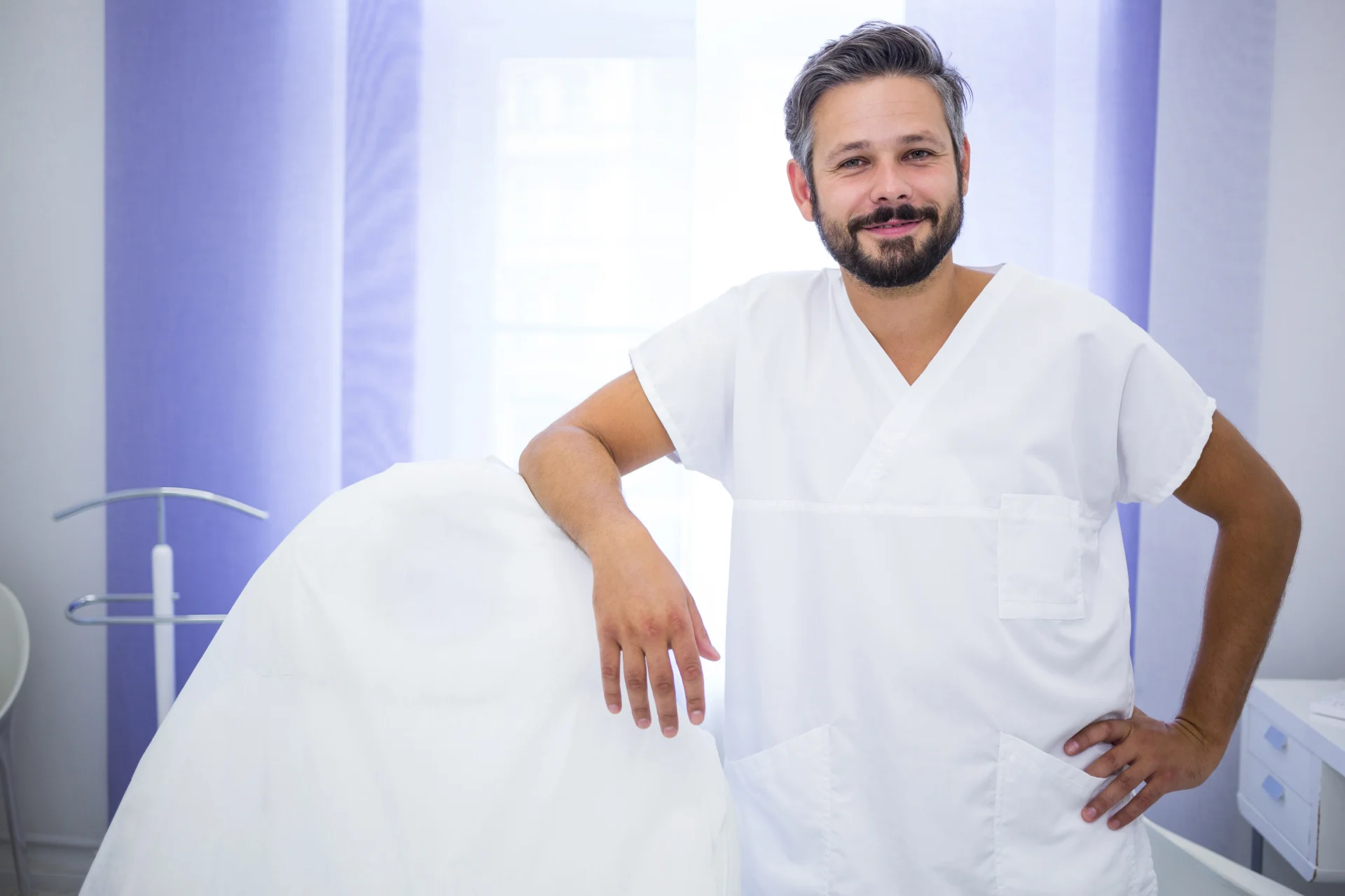 smiling-doctor-standing-clinic